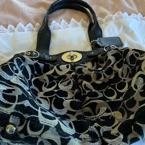 Coach soft material bag. Handles, purple three section interior.Turn metal clasp